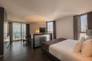 Cama ou camas em um quarto em RR Hotel da Rocha