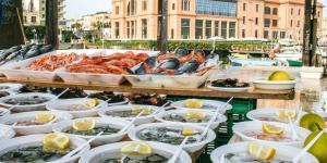 a display of seafood on a table in a harbor at Residenze Benedetto Croce in Bari