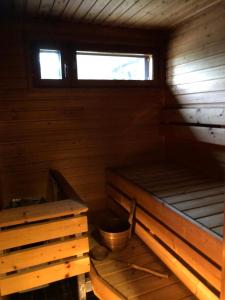 an empty cabin with a bench and a window at Saimaa Style Spa Chalet in Imatra