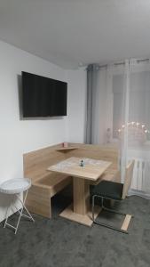 a wooden table and a chair in a room at Fewo Peter Erholungsort Bärenstein in Bärenstein