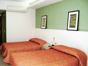 Postel nebo postele na pokoji v ubytování Hotel Los Cocos Chetumal