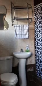 y baño con lavabo blanco y aseo. en Nice studio in historic center with private bathroom and kitchen!, en Cusco