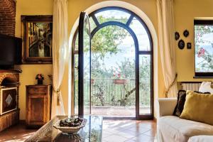 a living room with a glass table and an open door at Villa Simba in Massa Lubrense