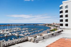 a view of a marina with boats in the water at Deluxe Marina Apartment - Azorean Butler in Ponta Delgada