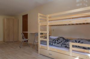 a bedroom with two bunk beds and a desk at Pawilon 12 in Sulejów