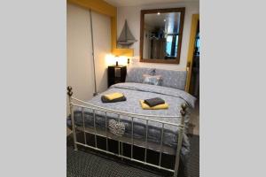 a bedroom with a bed with yellow pillows on it at The Old Boat House in Carlingford