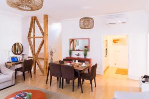 a dining room with a table and chairs at Chiado Spacious and Luxurious by Courtesy Morning in Lisbon