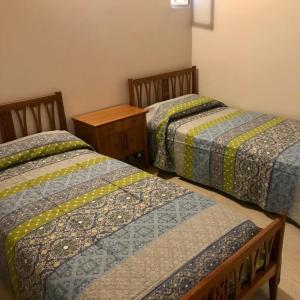 two beds sitting next to each other in a room at Departamento Nuevo in San Juan