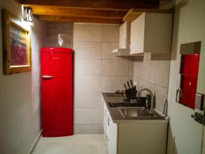 a red refrigerator in a kitchen with a sink at Cathedral Studio in Las Palmas de Gran Canaria