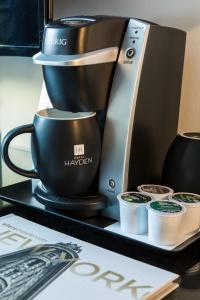 a coffee maker sitting on top of a coffee cup at Hotel Hayden New York in New York