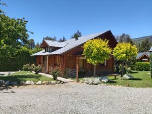 a log house with a gravel driveway in front of it at El Aguila in San Carlos de Bariloche