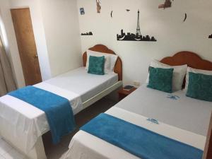 A bed or beds in a room at Hotel Monaco De Riohacha