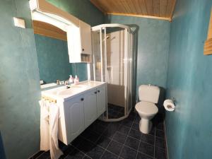 a blue bathroom with a sink and a toilet at Eggum Fishermans Cabin in Bøstad