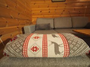 a bed with a quilt on it in a room at Eggum Fishermans Cabin in Bøstad