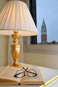 a lamp and a book and glasses on a table at House 5286 in Venice