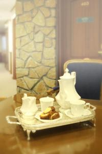 a tea set on a table with a plate with food at Afkos Grammos Boutique Hotel Resort in Nestorio