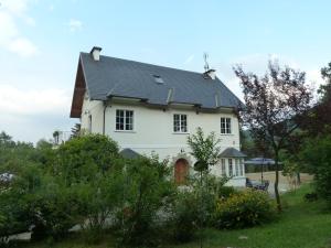 a white house with a black roof at Caterina.C B&B in Val Della Torre