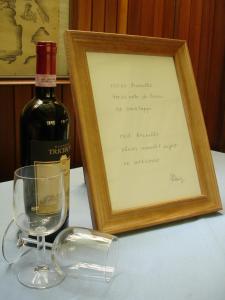 a bottle of wine sitting next to a wine glass at Hotel Signorini in Castiglioncello