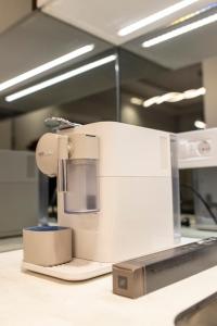 a white sewing machine sitting on top of a counter at Pupin Palace Apartments in Novi Sad