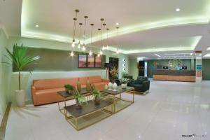 a living room with a couch and a table at Primme Hotel Aracaju in Aracaju