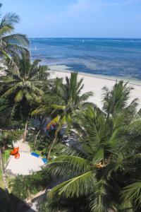 an aerial view of a beach with palm trees and the ocean at Stylish Beachfront Apartment Mombasa King Sized bed in Mombasa