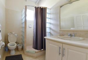 a bathroom with a toilet and a sink and a shower at Best E Villas Providence in Christ Church