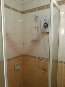 a shower in a bathroom with a shower at Dorcas Service Apartment - Marina Court in Kota Kinabalu