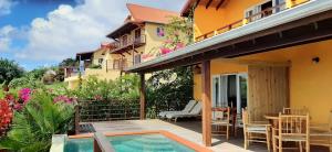 a house with a patio and a swimming pool at Kaye Mango in Soufrière