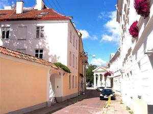 a car parked on a street between two buildings at President Apartments in Vilnius