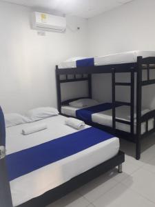 two bunk beds sitting next to each other in a room at Hotel Don Toño Tolú in Tolú