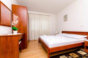 een slaapkamer met een groot bed in een kamer bij Apartments Luka in Trogir