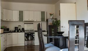 a kitchen with white cabinets and a table at House in Cusco in Cusco