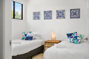 מיטה או מיטות בחדר ב-Villa Provence Coffs Harbour
