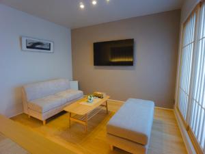 a living room with a couch and a table at GRAND BASE Hakata Sumiyoshi in Fukuoka