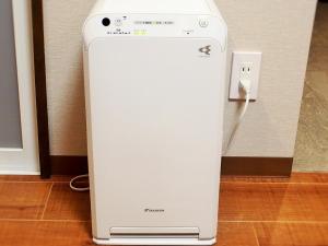 a whiteintendo wii game system next to an outlet at Smart Condo Tomari in Naha