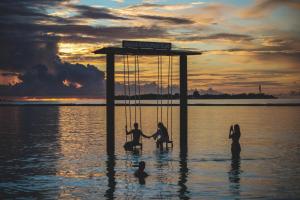 a group of people sitting in the water at Adaaran Prestige Water Villas - with 24hrs Premium All Inclusive in Raa Atoll