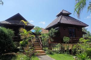 a house with a staircase leading up to it at Thai House Beach Resort in Ko Lanta