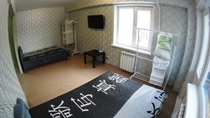 a small room with a bed and a window at Apartments on Prospekt Dimitrova in Novosibirsk