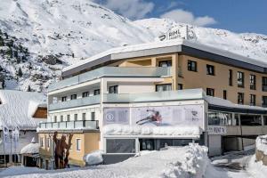ein Gebäude mit einem schneebedeckten Berg im Hintergrund in der Unterkunft Piccard Nº 5 in Obergurgl