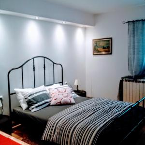 a bedroom with a large bed with pink pillows at Alexandar in Belgrade