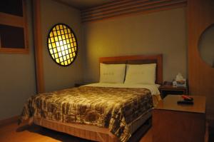 En eller flere senger på et rom på Motel Daeha