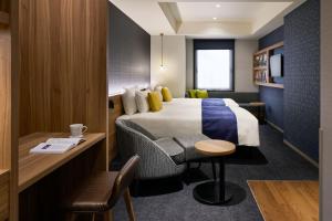 a hotel room with a bed and a desk at the b akasaka-mitsuke in Tokyo