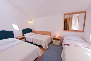 a hotel room with two beds and a mirror at MalAna in Zaton