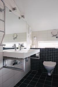 a bathroom with a sink and a toilet at Björholmen Hotell & Restaurang in Björholmen