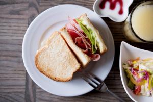 a sandwich and salad on a plate with a cup of coffee at the b akasaka-mitsuke in Tokyo