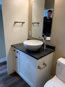 a bathroom with a sink and a mirror at Botany Bay by Eagle Reach Properties in Port Renfrew