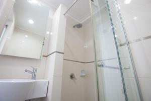 a bathroom with a shower, sink, and toilet at Tune Hotel - Waterfront Kuching in Kuching