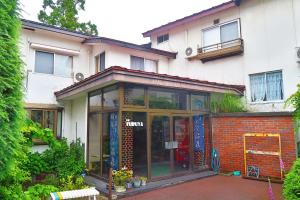 um edifício com portas de vidro à sua frente em 旅館FURUYA em Hakuba