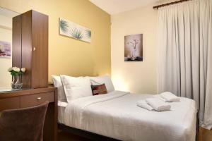 a bedroom with a bed with two towels on it at COUNTRY PLACE Apartment with mountains view in Ioannina