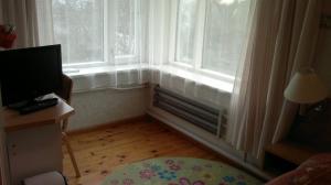 a room with a window with a radiator and a television at Transvaali 28 B&B in Kuressaare